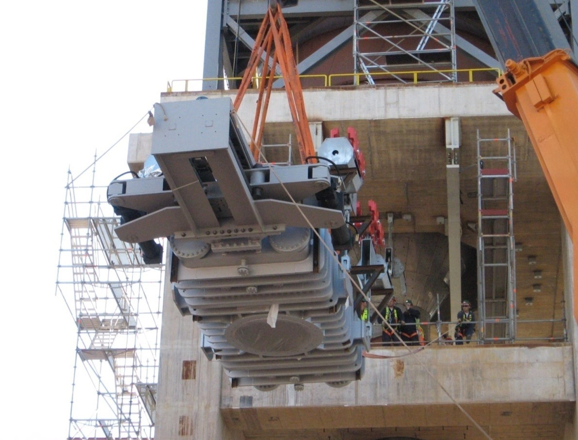 Workers install a massive 60-ton IMI Z&J valve at an industrial site, requiring careful coordination and heavy equipment.