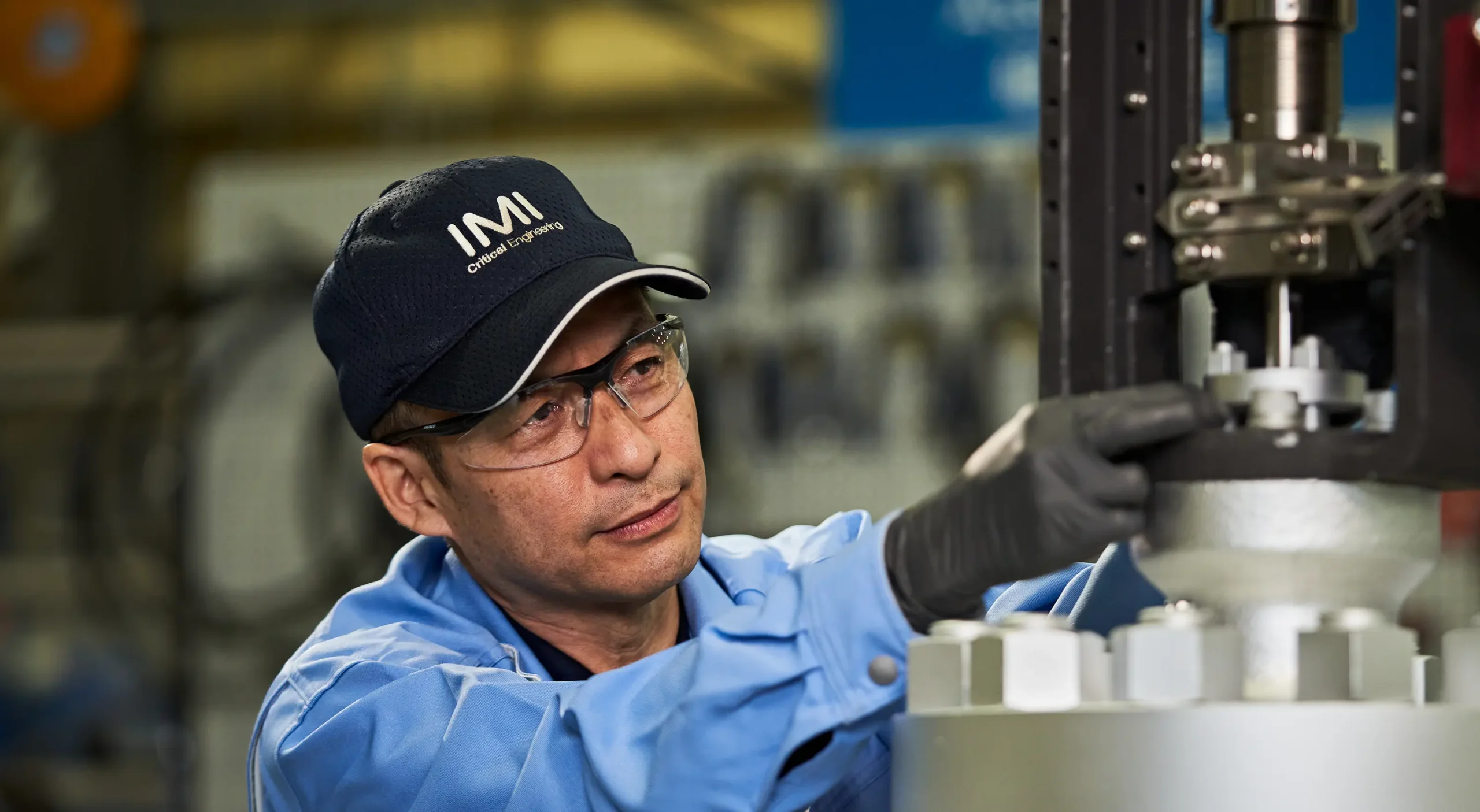 Skilled worker inspects control valve at IMI facility in Kobe, ensuring precision and safety.