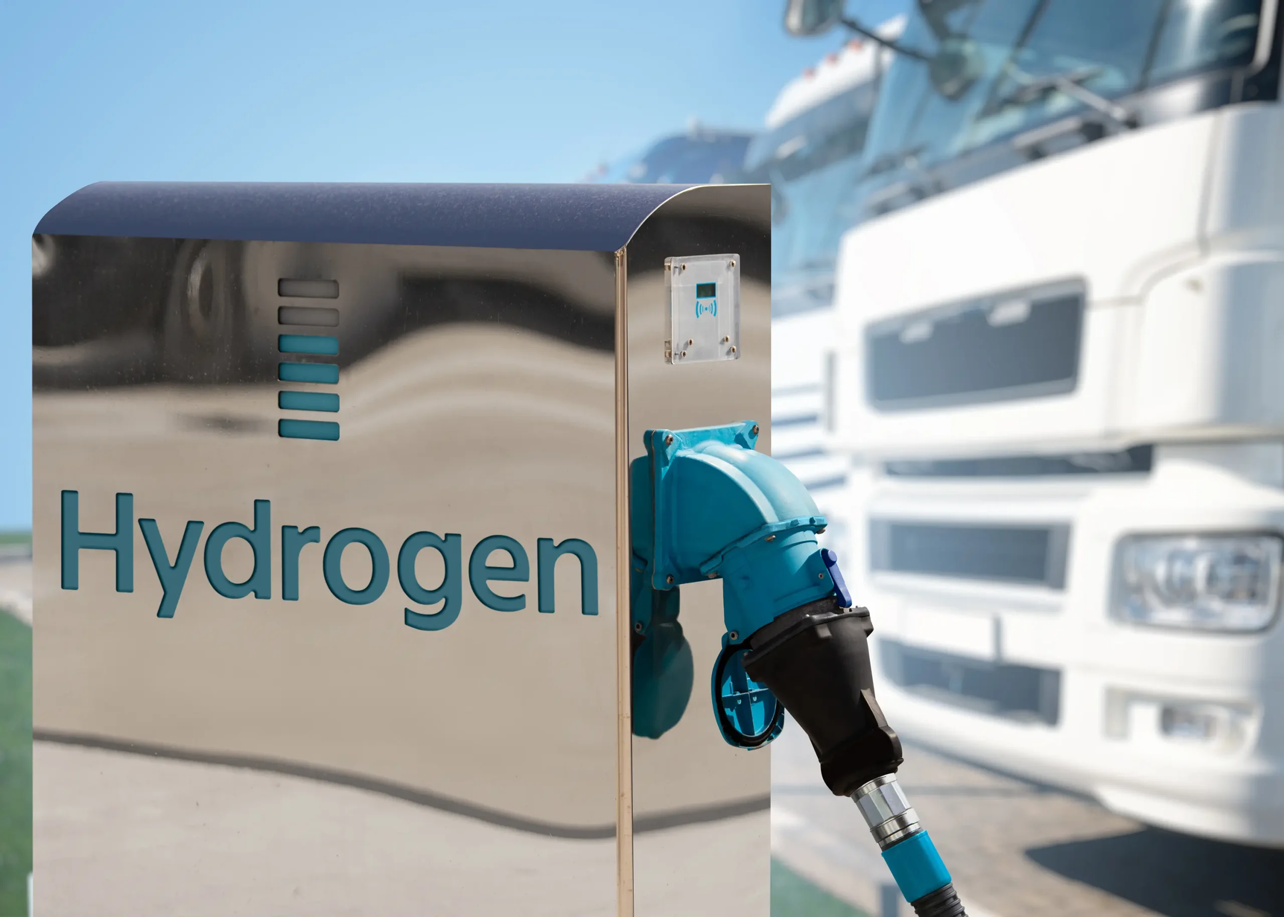 Hydrogen filling station with electrolysers enabling clean and sustainable refueling amidst a fleet of trucks.