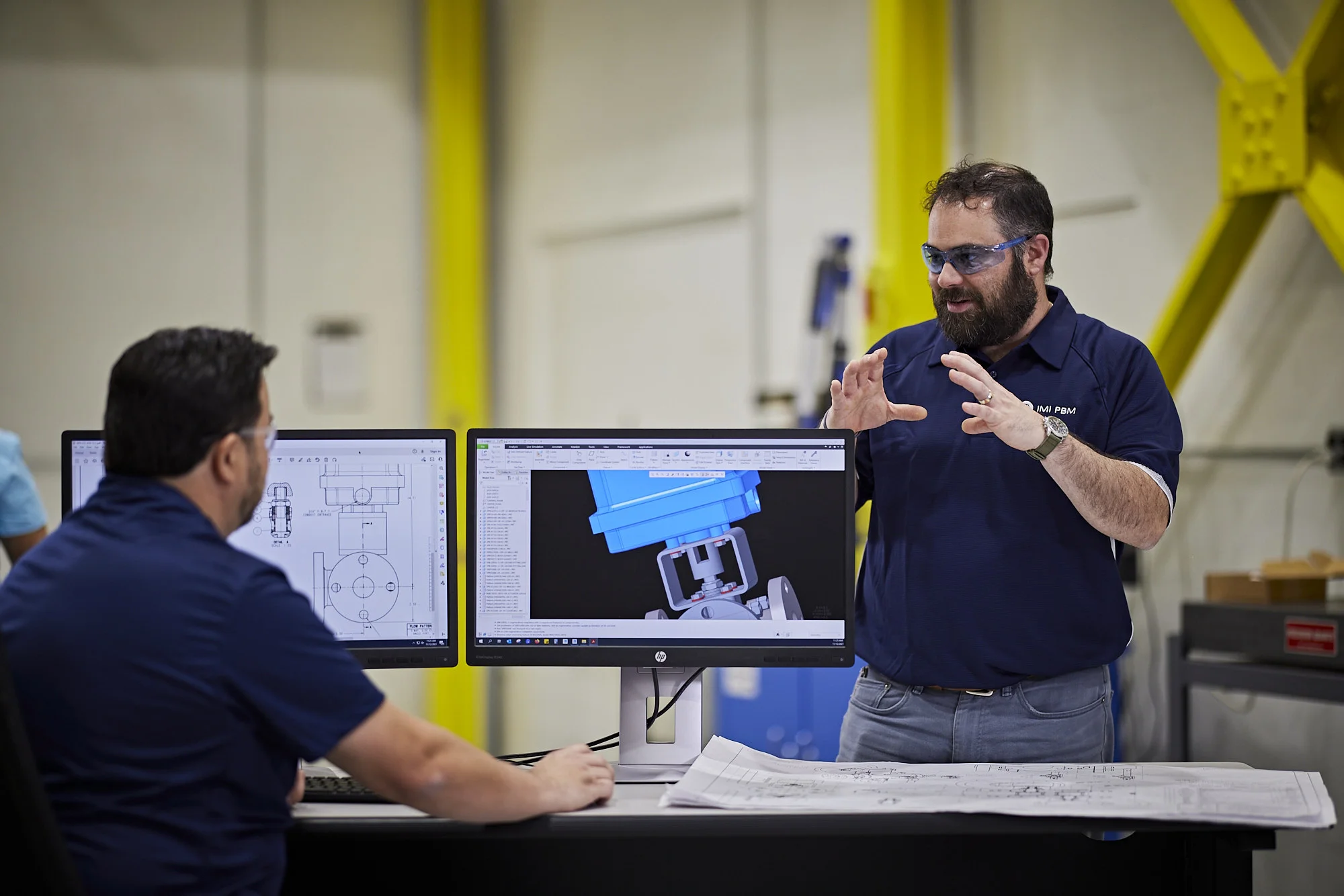 IMI PBM engineers in intense discussions, combining expertise and creativity, shaping the design of an innovative valve product for fine chemical manufacturing.
