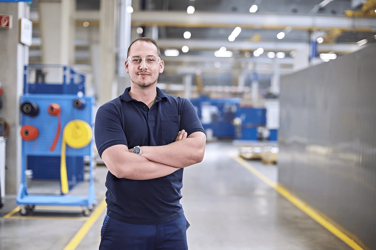 IMI engineer poses at regional manufacturing facility