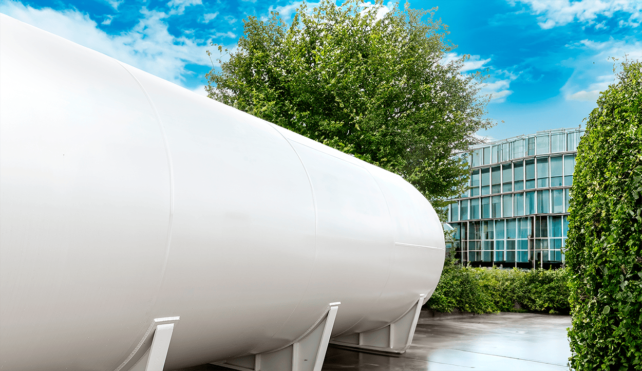 An image that shows a large hydrogen storage tank outside an office building