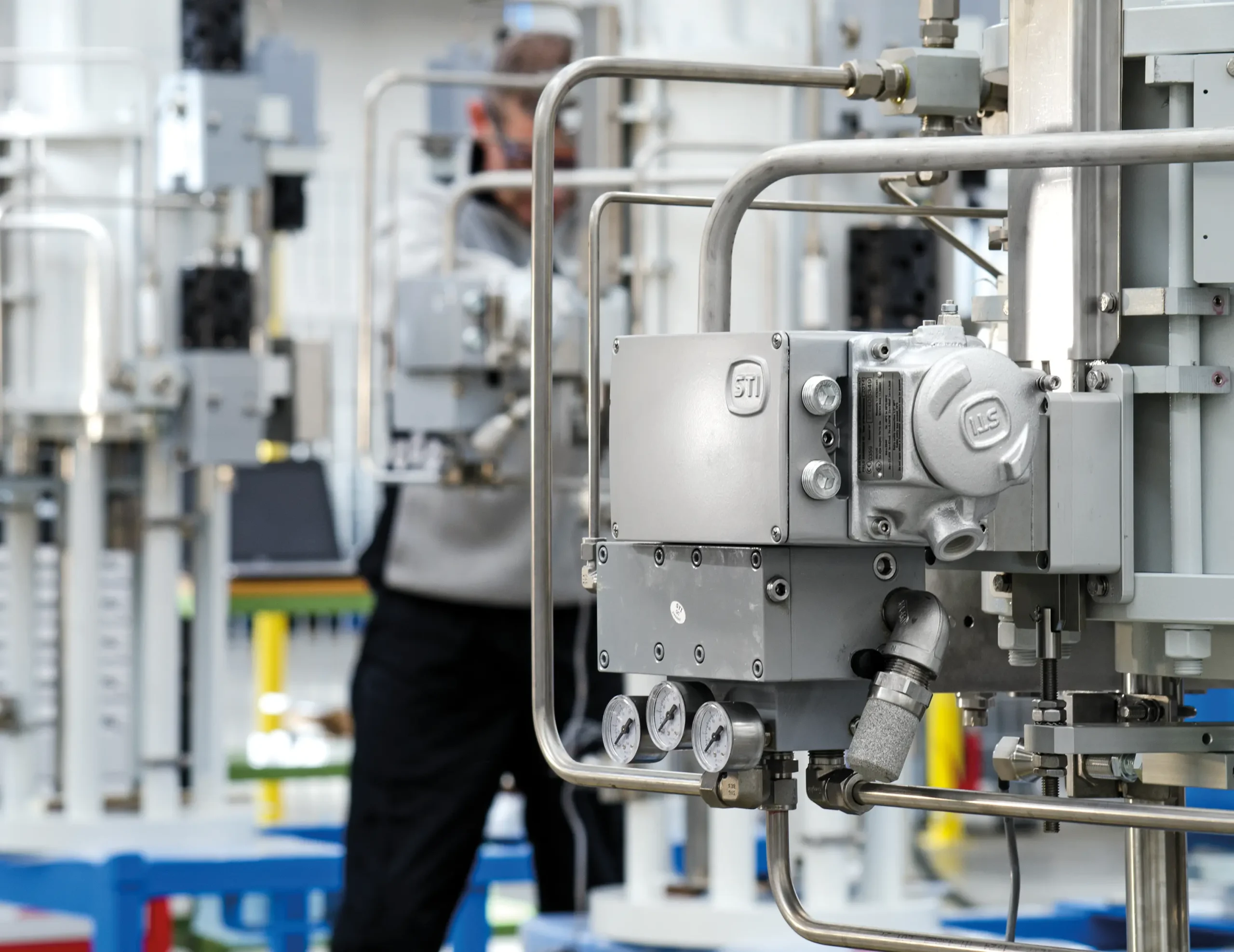 Skilled workers at an Italian facility produce IMI STI actuators using advanced machinery, ensuring high-quality manufacturing standards.