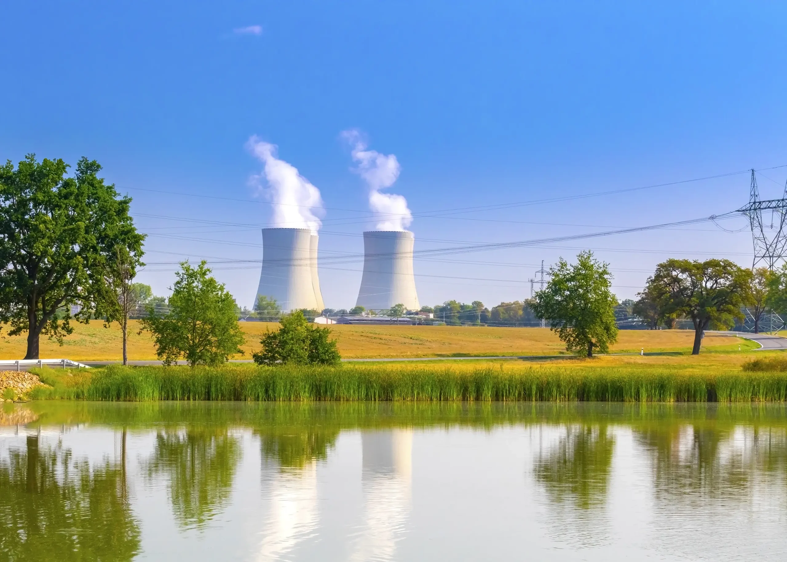 This image of a lake and nuclear power station serves as a reminder of the critical importance of well-maintained flow control systems in ensuring safe and reliable operation.