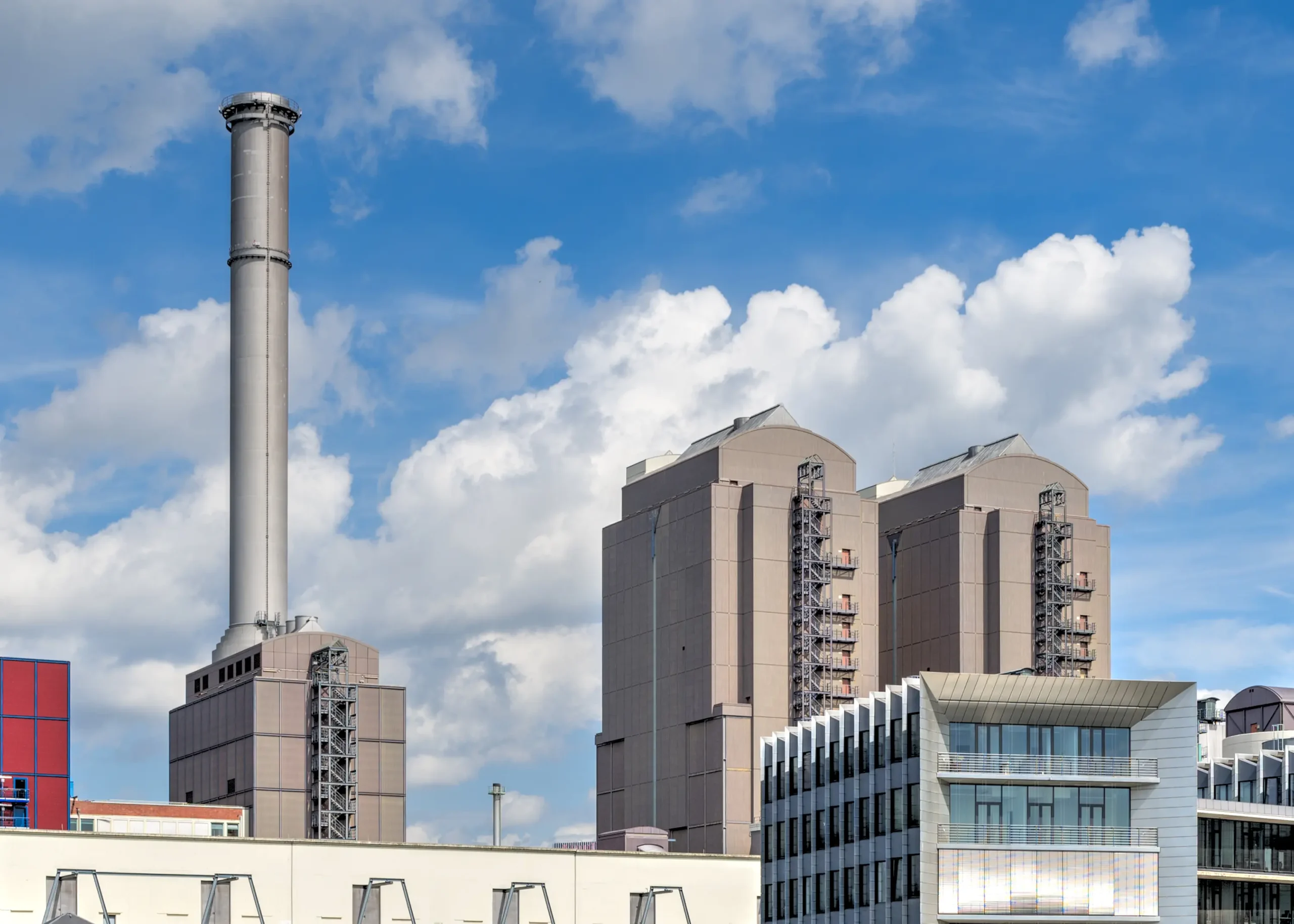 Commanding the view at Frankfurt's western harbor, a powerful plant stands tall, complemented by the River Main, chimneys, and industrial structures.
