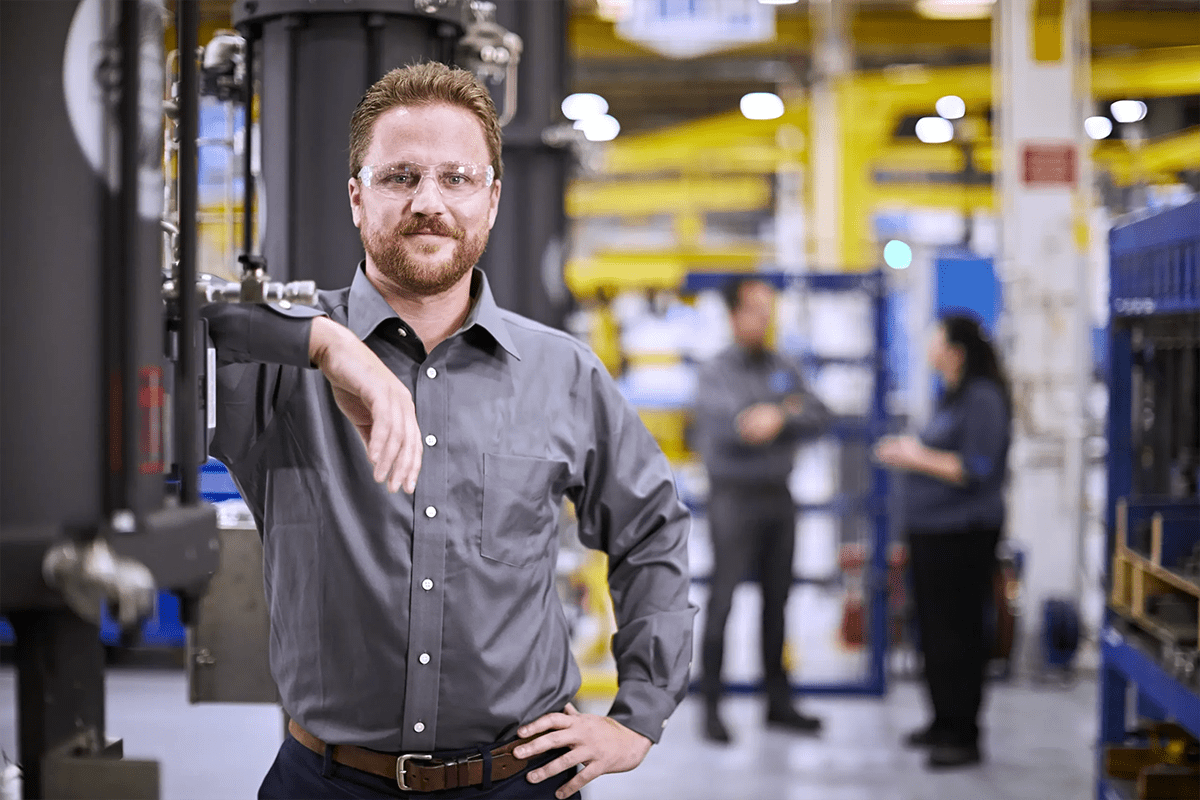 Engineer poses with choke valve at site in California