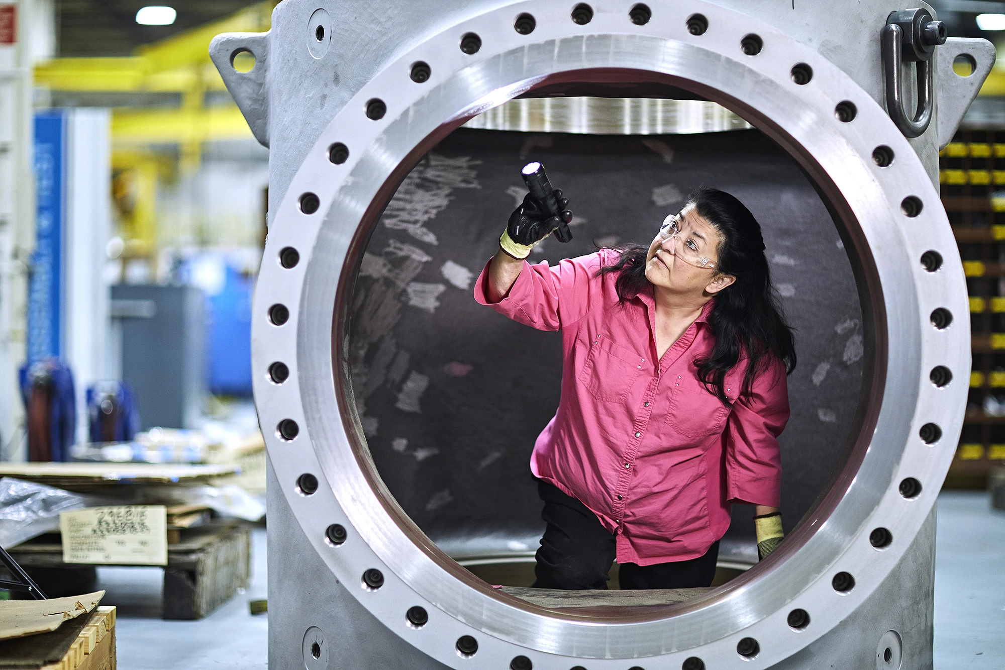 An engineer completes a quality inspection on a control valve body by checking it for any defects or irregularities that could affect its performance.