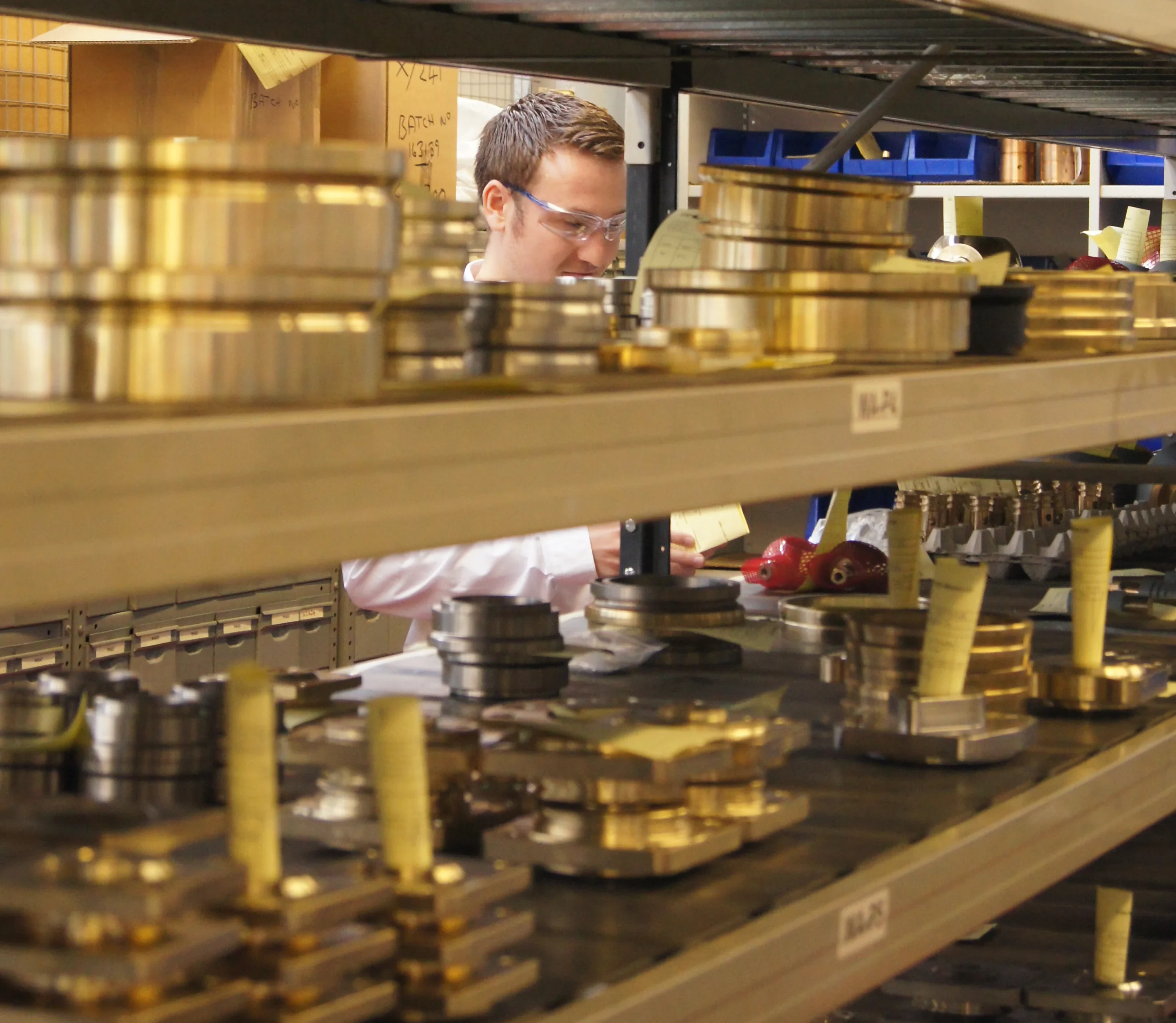 In the busy workshop of IMI Truflo Marine, a handsome man captivates onlookers as he expertly checks valve components with precision.