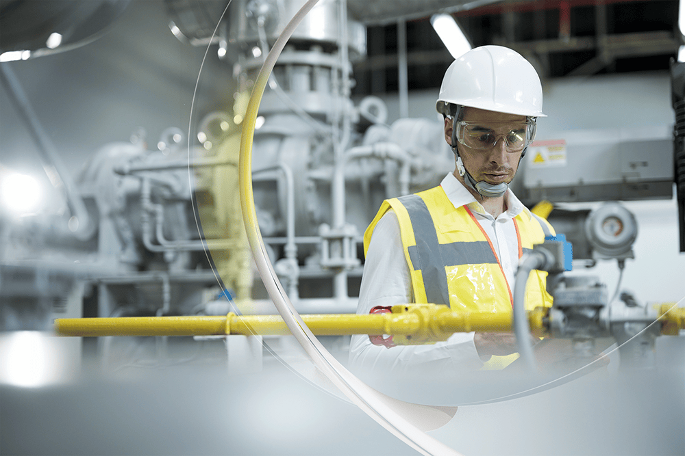 Man inspects pipe at facility