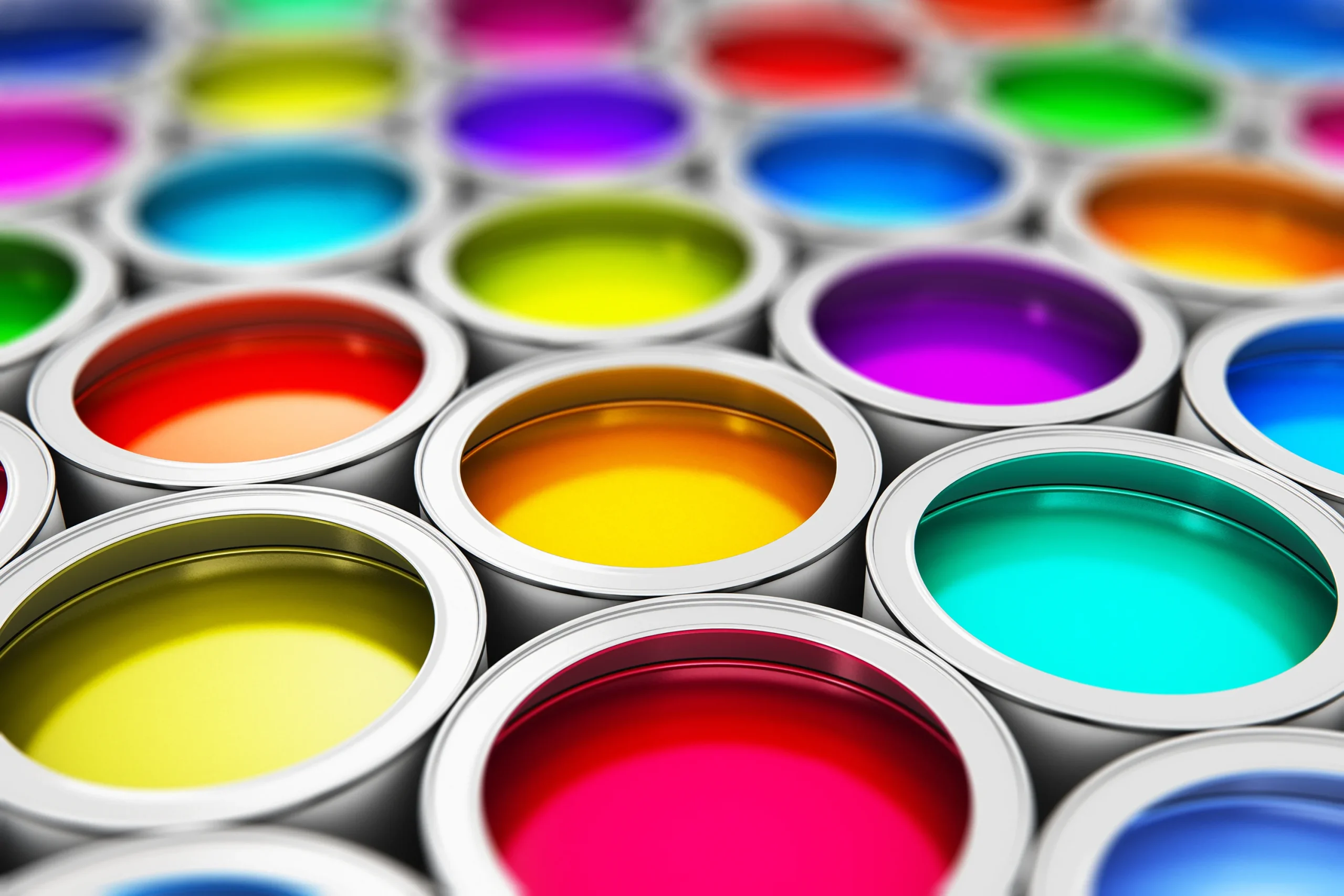 Vibrant paint cans lined up, emphasising the importance of clean systems in paint production for flawless results and product quality