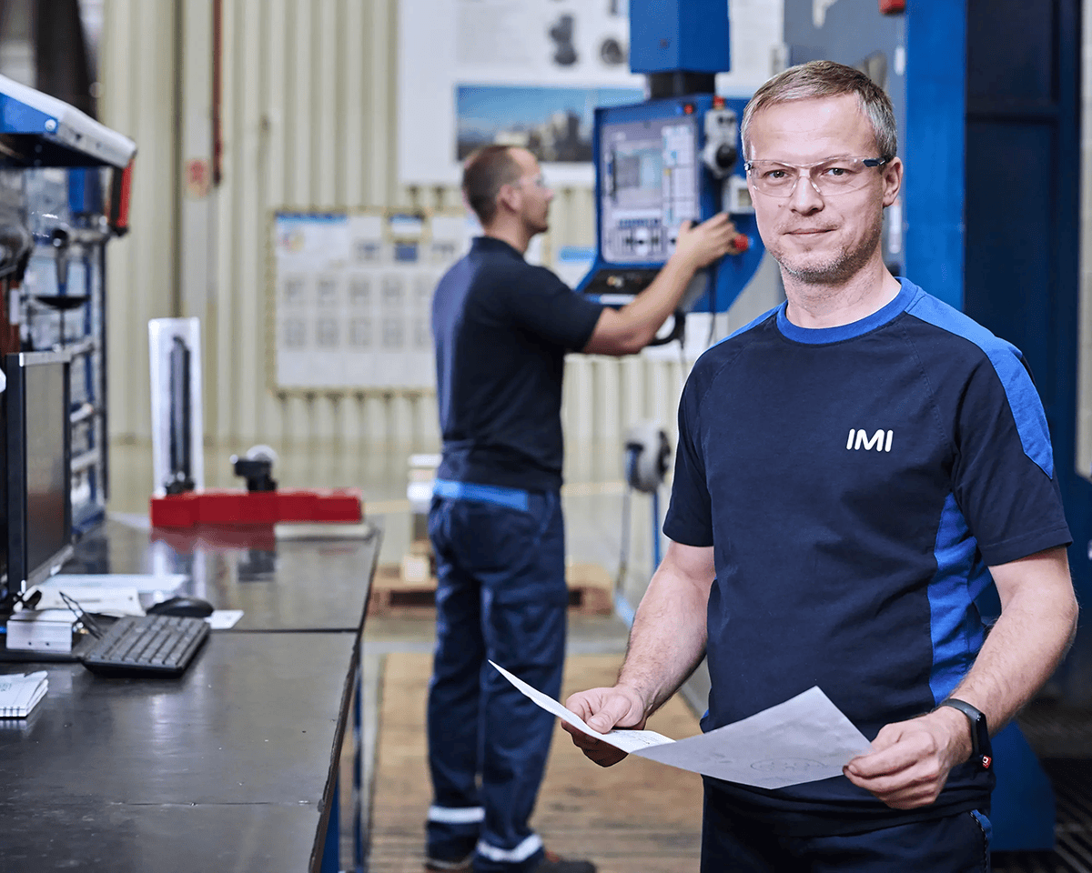 Machine operators inspect drawings
