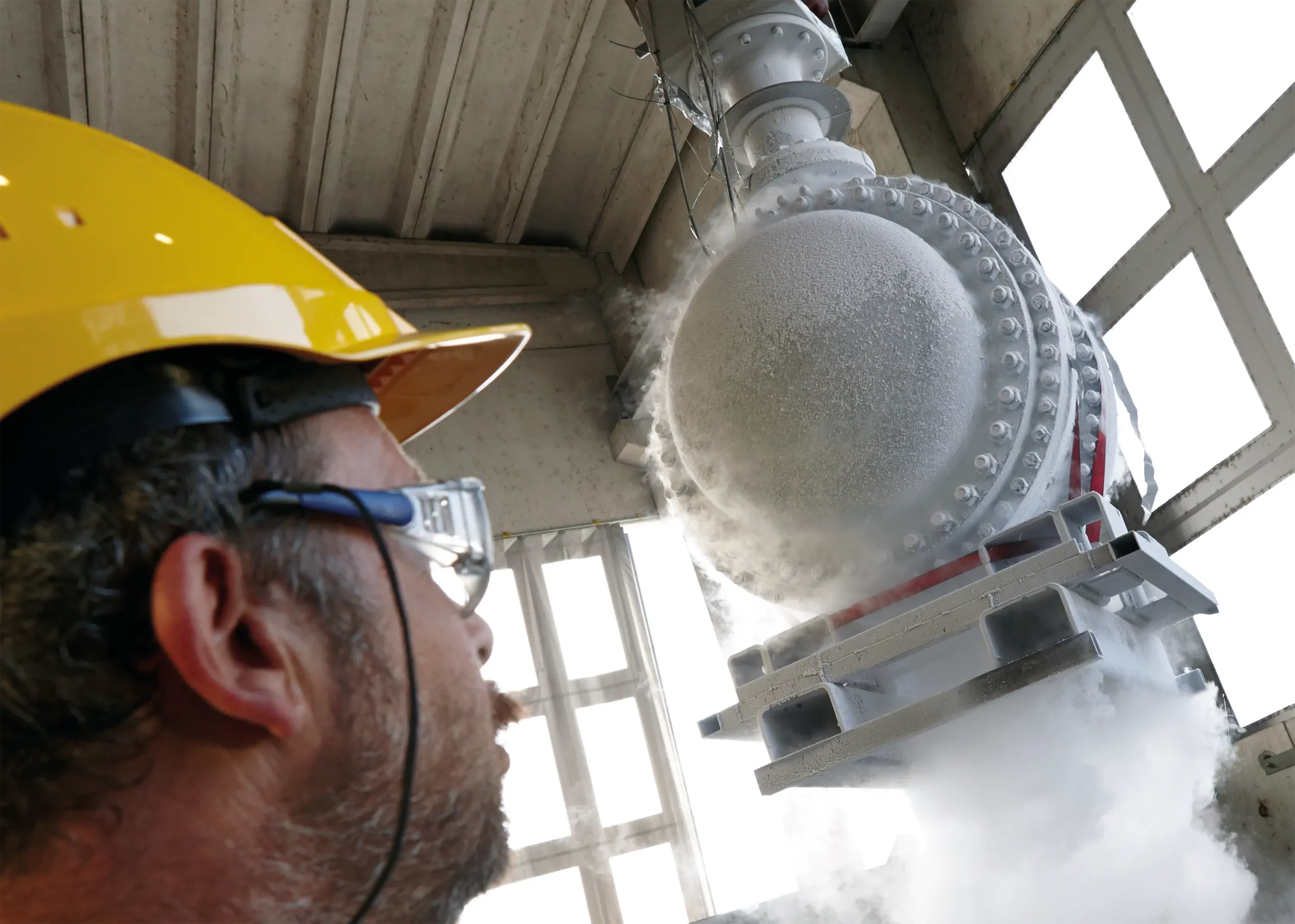 Engineer oversees cryogenic testing of a large valve at IMI Orton, ensuring durability and performance in extreme conditions.