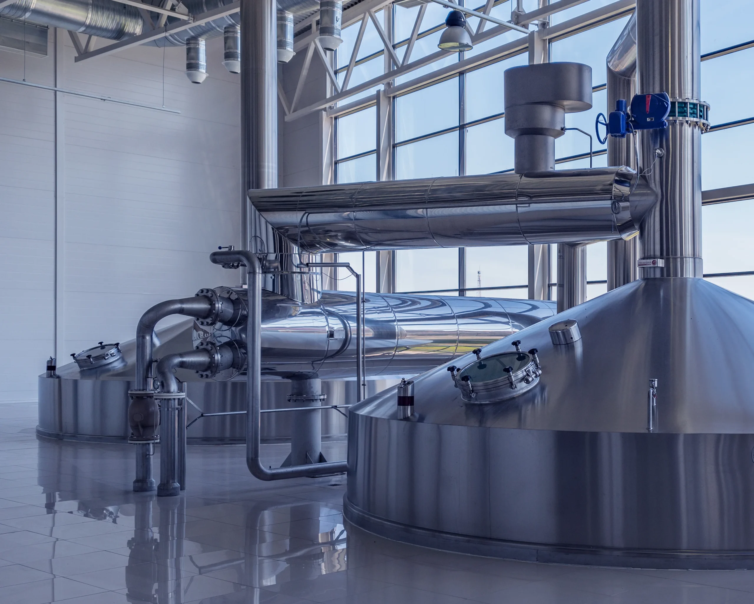 Brewing equipment neatly arranged with a large window in the background, creating a bright and inviting atmosphere
